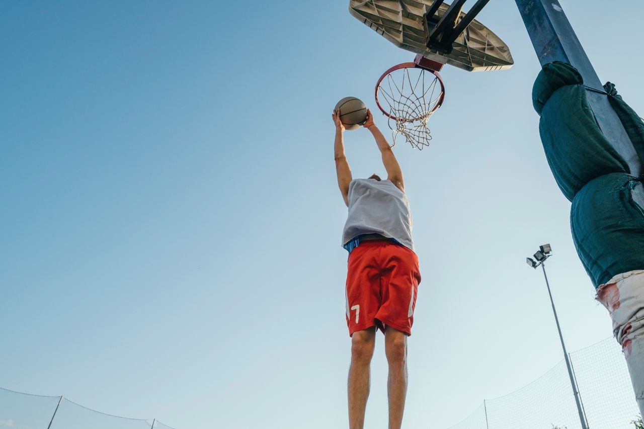 Man jumping for basketball hoop